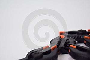 Close up concept black and orange spring clamping isolated on white background