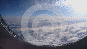 Close-up of condensate water drops on aircraft porthole. Risk of air accident