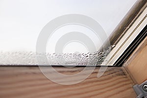 Close up of condensation on velux window in a house, water drops and hight humidity photo