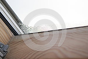 Close up of condensation on velux window in a house, water drops and hight humidity photo