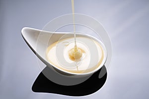 Close up of condensed milk isolated on the table background, food and dessert concept