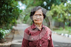 Close up confident Asian grandma wearing eyes glasses