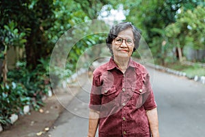 Close up confident Asian grandma wearing eyes glasses