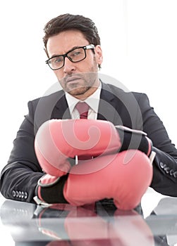 Close up.confident businessman Boxing gloves sitting at his Desk