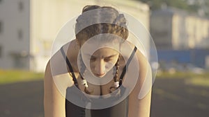 Close-up of confident concentrated sportswoman raising face and start running. Beautiful young slim Caucasian woman