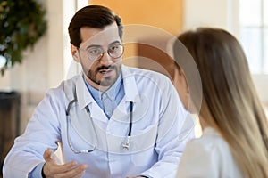 Close up confident doctor consulting young woman at meeting