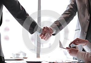 Close up.confident handshake of business people in the office