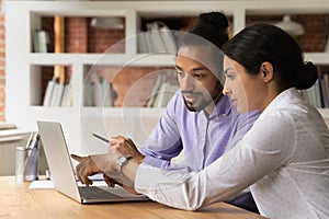 Close up confident Indian businesswoman mentor teaching African American intern