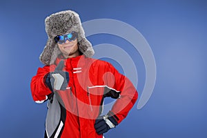 Close up of confident man standing in winter hat and coat.