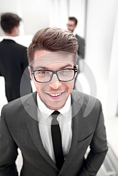 Close up.confident young businessman on blurred office background