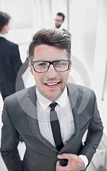 close up.confident young businessman on blurred office background