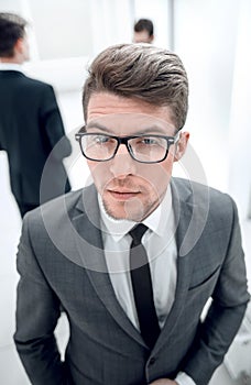 close up.confident young businessman on blurred office background