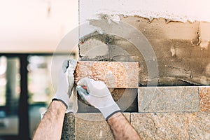 close up of construction builder working with stone and paving