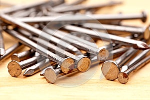 Close-up of construction nails on wood