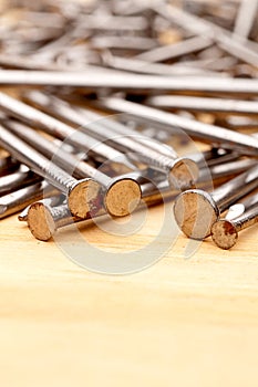 Close-up of construction nails on wood