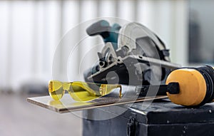 Close up of construction safety goggles and work tools.