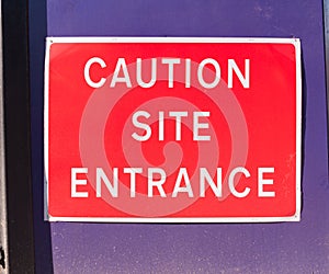 close up construction site sign red caution site entrance