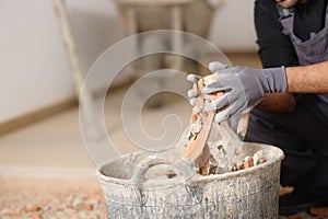 Construction worker hands removing debris to a carrycot
