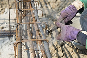 Close up of construction worker hands working with pincers