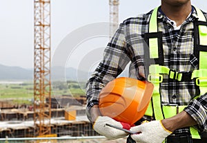 Close up construction worker holding helmet photo