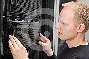 Close-up of It consultant installing server in datacenter