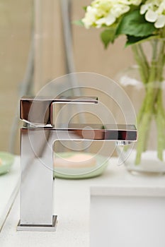 Close up of a contemporary square shaped mixer tap