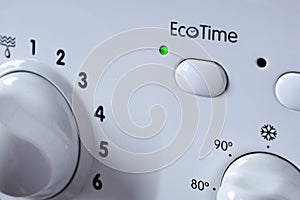 Close-up of the control panel of a washing machine. Selective focus on the eco selector