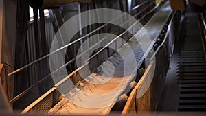 Close up of conveyor belt with white cloth. Stock footage. Industrial background inside the workshop of the factory and