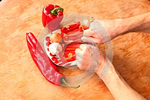 Close-up. Cook hands cutting up a salad