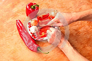 Close-up. Cook hands cutting up a salad