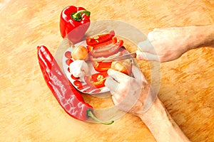 Close-up. Cook hands cutting up a salad