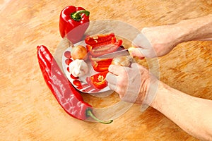 Close-up. Cook hands cutting up a salad