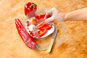 Close-up. Cook hands cutting up a salad