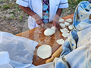 Close up of cook hands flipping Argentinian frybreads to cook on both sides. Sopaipilla. Traditional foods photo
