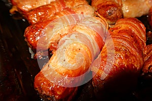 Close up of cooked Sausages wrapped in Bacon