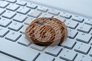 Close-up of a cookie on a computer keyboard.