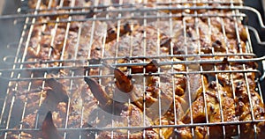 A close up of the cooking chickens on grill