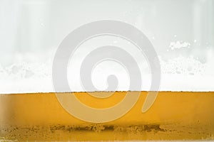Close up of cool lager beer splash isolated on white background with realistic bubbles