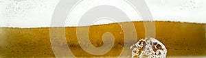 Close up of cool lager beer splash isolated on white background with realistic bubbles