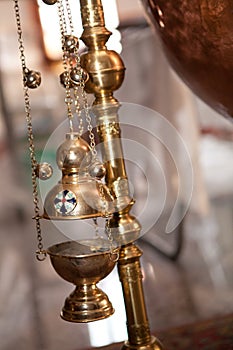 Close up of a copper float light for frankinscence with bells
