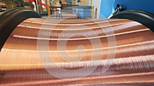 Close up of copper wire getting reeled onto a massive spool