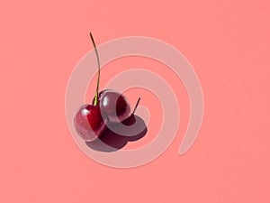 Double cherry on pink bright background