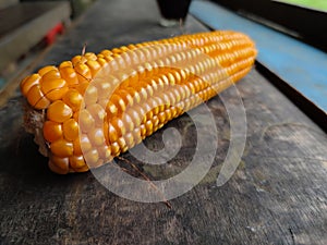 close up, corn without husks on a wooden table