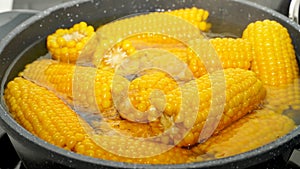 Close-up corns boiling in a pot
