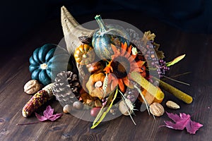 Close up of a cornucopia centrepiece filled with various autumn decorations photo