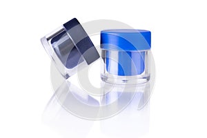 Close-up of a cosmetic cream container on a white background with a beautiful reflection, isolated