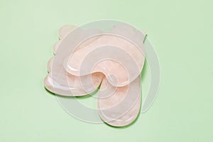 Close Up Cosmetic Massage Pink Jade Gua Sha Scrapers for Facial and Body Skin Care Spa and Beauty Concept Green Background