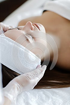 Close up of cosmetologist do beauty face procedures or treatment to woman client in aesthetic medicine clinic