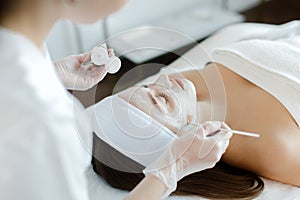 Close up of cosmetologist do beauty face procedures or treatment to woman client in aesthetic medicine clinic