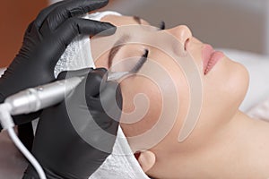 Close up cosmetologist making eyeliner permanent makeup